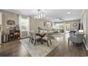 Open concept dining area with seating for four and hardwood floors at 301 Climbing Vine Ct., Conway, SC 29526