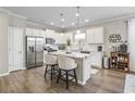 Modern kitchen with white cabinets, stainless steel appliances, and an island at 301 Climbing Vine Ct., Conway, SC 29526