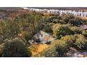 Aerial view of home surrounded by mature trees and landscaping near the Waccamaw River at 356 Rossdhu Ave., Pawleys Island, SC 29585