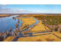 Beautiful river view with natural landscaping and boat docks at 356 Rossdhu Ave., Pawleys Island, SC 29585