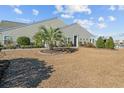 Home's backyard featuring a well maintained lawn and a palm tree at 4463 Livorn Loop # 4463, Myrtle Beach, SC 29579