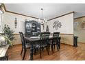 An elegant dining room with a chandelier, a large dining table, and sophisticated decor and wooden floors at 702 Plantation Dr., Surfside Beach, SC 29575