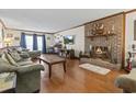 Comfortable living room with a warm fireplace, hardwood floors, and stylish decor and furniture for relaxing or entertaining at 702 Plantation Dr., Surfside Beach, SC 29575