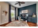 Cozy home office features a custom built-in desk, ample natural light, and hardwood floors at 8605 Hopper Ct., Myrtle Beach, SC 29579