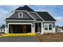 New gray craftsman style home with attached garage at 973 Oak Hollow St., Longs, SC 29568