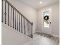 Bright entryway with an ornate staircase and a white front door at 141 Ranch Haven Dr., Murrells Inlet, SC 29576