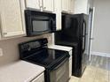 Kitchen with black appliances and light wood cabinets at 2013 Silvercrest Dr. # 30-A, Myrtle Beach, SC 29579