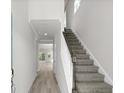 Bright entryway showcasing a staircase with carpeted steps and wood handrail, leading to an open living space at 2048 Copper Creek Loop, Longs, SC 29568