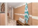 Inviting entryway with bench, hooks, and beach towel at 205 74Th Ave. N # 1601, Myrtle Beach, SC 29572