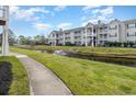 Building exterior showcasing a tranquil pond and walking path at 3762 Citation Way # 1018, Myrtle Beach, SC 29577