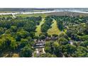 Aerial view of a community golf course surrounded by lush trees and winding waterways at 92 Patriot Ct., Georgetown, SC 29440