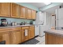 Efficient kitchen with wood cabinets, appliances, and stackable washer/dryer at 400 20Th Ave. N # 303, Myrtle Beach, SC 29577