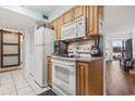 White appliances and wood cabinets in this galley kitchen at 400 20Th Ave. N # 303, Myrtle Beach, SC 29577