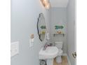Small half bathroom with white pedestal sink and beachy decor at 451 Cypress View Ave., Little River, SC 29566