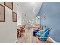 Open-concept living space with tall ceilings, modern lighting, and coastal-inspired decor at 859 Tall Oaks Ct. # A, Myrtle Beach, SC 29588