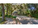 Scenic entrance to Wedgefield Plantation featuring a brick gatehouse and lush greenery at 934 Francis Parker Rd., Georgetown, SC 29440