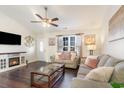 Cozy living room with a fireplace, neutral-toned furniture, and a large window for natural light at 1049 Augustus Dr., Conway, SC 29527