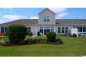 Well-maintained backyard with lush green grass and beautiful landscaping at 135 Parmelee Dr. # D, Murrells Inlet, SC 29576