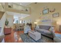 Open living space with hardwood floors, loft, and views into the dining area and kitchen at 280 B Connemara Dr. # B, Myrtle Beach, SC 29579