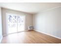 Bright living room with hardwood floors and sliding door to balcony at 300 47Th Ave. S # 1C, North Myrtle Beach, SC 29582