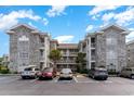 Two-story building exterior with brick facade and parking lot at 4753 Wild Iris Dr. # 104, Myrtle Beach, SC 29577