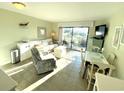 Bright living room with tile floors and access to a balcony at 5905 S Kings Hwy. # B130, Myrtle Beach, SC 29575