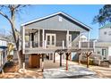 Modern two-story home with gray siding and a large deck at 6001 - 1450 S Kings Hwy., Myrtle Beach, SC 29575