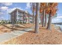 Building exterior along a waterway with fall foliage at 706 Riverwalk Dr. # 303, Myrtle Beach, SC 29579