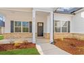 Inviting front entrance with a stylish door, columns and well-kept landscaping, adding curb appeal at 800 Caines Landing Rd., Conway, SC 29526