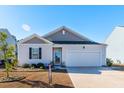 House exterior with vinyl siding, landscaping, and a two-car garage at 127 Marauder Dr., Longs, SC 29568