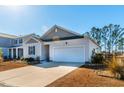 Two-car garage, vinyl siding, and nicely landscaped front yard at 127 Marauder Dr., Longs, SC 29568