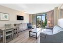 Cozy living space with dining area, sleeper sofa, and balcony access at 1501 S Ocean Blvd. # 251, Myrtle Beach, SC 29577