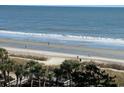 Expansive beach view with ocean waves and palm trees at 2001 S Ocean Blvd. # 718, Myrtle Beach, SC 29577