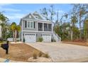 Two-story home with two car garage, and a spacious driveway at 22 Trigger Fish Ln., Murrells Inlet, SC 29576