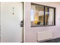 Exterior condo entry door with a window showing the bedroom at 2406 N Ocean Blvd. # 604, Myrtle Beach, SC 29577