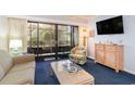 Living room with comfy seating, balcony access, and TV at 415 Ocean Creek Dr. # 2280, Myrtle Beach, SC 29572
