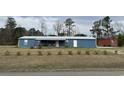 Charming single-story home featuring a metal roof, covered porch, and a spacious front yard at 445 W Willow Pond Rd., Johnsonville, SC 29555