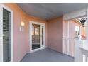 Covered entryway with glass front door and access to a balcony at 4650 Lightkeepers Way # 21D, Little River, SC 29566