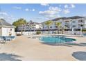 Community pool with surrounding lounge chairs at 4847 Carnation Circle # 203, Myrtle Beach, SC 29577