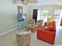Cozy living room showcases colorful seating, a TV stand, and a sliding glass door to a balcony at 507 S Ocean Blvd. # 201, North Myrtle Beach, SC 29582