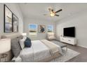 Spacious bedroom with carpet flooring features natural light from large windows and a ceiling fan at 556 Honeyhill Loop, Conway, SC 29526