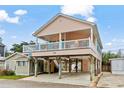 Two-story beach house with a wrap-around deck and parking underneath at 6001 - 1563 S Kings Hwy., Myrtle Beach, SC 29575