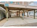 Under-house parking area for beach house with concrete floor at 6001 - 1563 S Kings Hwy., Myrtle Beach, SC 29575