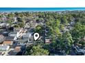 Aerial view of the neighborhood, nestled among lush trees, with the ocean visible in the distance at 6001 South Kings Hwy., Myrtle Beach, SC 29575