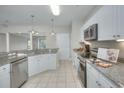 Bright kitchen with granite countertops and white cabinets at 70 Addison Cottage Way # 319, Murrells Inlet, SC 29576