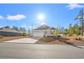 Attractive one-story house with a two-car garage and manicured lawn at 747 Coquina Bay Dr., Conway, SC 29526