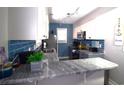 Well-lit kitchen featuring modern appliances, stylish countertops, and beautiful blue backsplash at 9620 Windchime Dr., Myrtle Beach, SC 29572