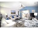 Comfortable living room with vaulted ceiling, sliding glass doors to deck and stylish decor at 9620 Windchime Dr., Myrtle Beach, SC 29572