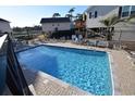 Sparkling community pool with ample seating and lounging areas, perfect for relaxation at 9620 Windchime Dr., Myrtle Beach, SC 29572