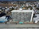 Aerial view of high rise building, pool, and beach at 1210 N Waccamaw Dr. # 702, Murrells Inlet, SC 29576